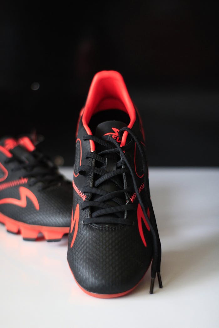 Sleek black sneakers with red accents, perfect for sports and casual wear.